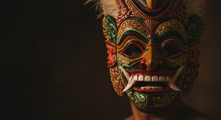 A performer sports a vibrant, intricately designed mask, celebrating cultural heritage