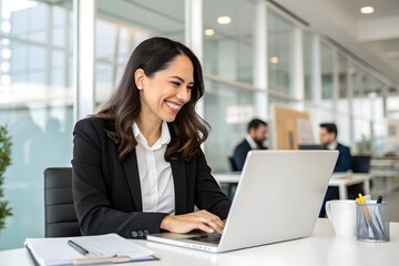 Fototapeta premium Smiling Female HR Manager Using Laptop at Work Desk in Corporate Office