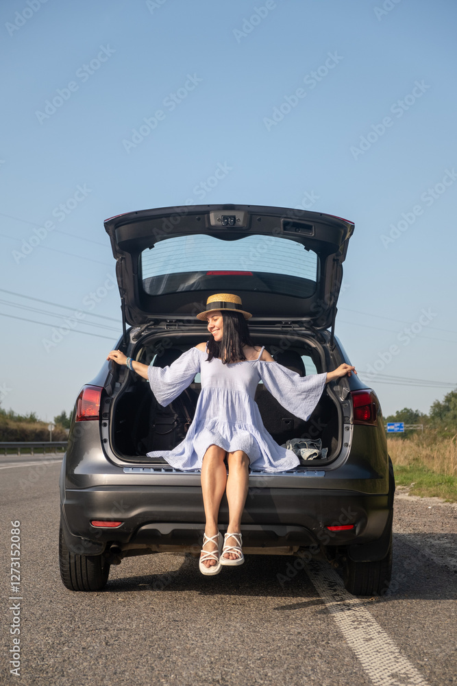 Wall mural Woman Enjoying a Sunny Day by Her Car