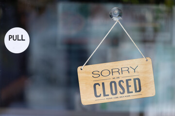 A sign hanging from a window that says Sorry I am closed