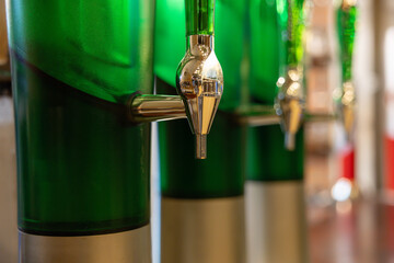 Three green bottles with a silver top and a green spout. alcohol dispenser of beer tower.