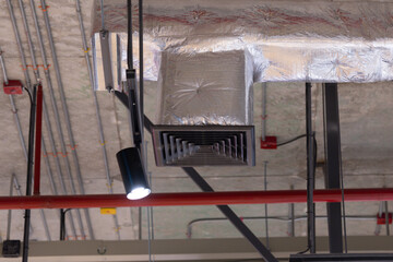 A light is shining on a vent in a building
