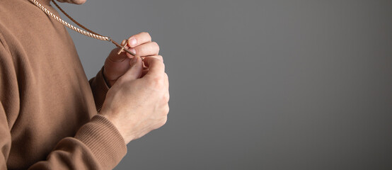 Caucasian man with a golden necklace and cross.