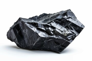 Naklejka premium Large black mineral rock with sharp edges and reflective crystalline structure isolated on a white background. Geology and natural stone formation concept.