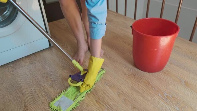 A cleaner attaches a cloth to the mop for cleaning. Regular cleaning reduces moisture and prevents mold growth.