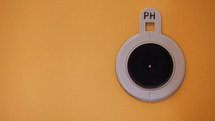 Pinhole, medical tool for use during optometrist eye exam. Vision test optometry equipment. Yellow...