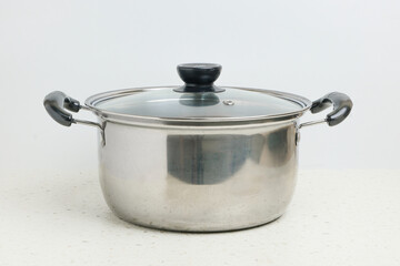 Stainless steel stewpot on white background