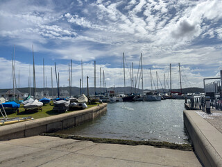 Knysna lagoon marina South Africa. Sailboats and yachts, blue cloudy sky