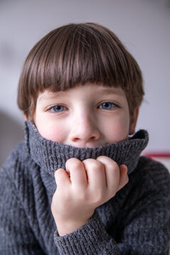 Young Boy with Blue Eyes in a Warm Turtleneck