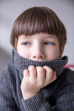 Young Boy with Blue Eyes in a Warm Turtleneck