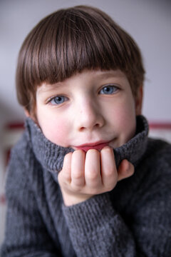 Young Boy with Blue Eyes in a Warm Turtleneck