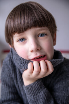 Young Boy with Blue Eyes in a Warm Turtleneck