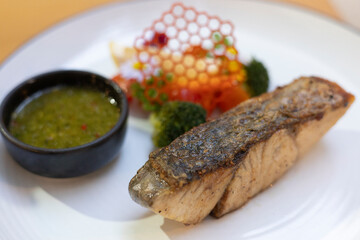Grilled fish, appetizer salmon, on white plate gourmet cuisine dish, bowl food seafood steak, crispy skin and sauce with green broccoli dipping elegant