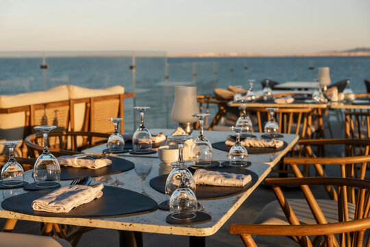 Beautifully arranged tables at a seaside restaurant with ocean views