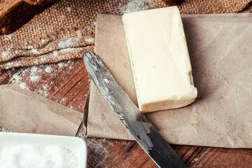 rye bread with raisins, dried apricots, sunflower seeds, caraway seeds, two loaves of bread on a wooden background, flour, sieve, rolling pin, eggs, homemade bread, wheat ears, black bread with butter