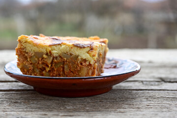  Potato and minced meat  Casserole  with   parmesan cheese and garlic on wooden rustic bakcground.  Bulgarian moussaka