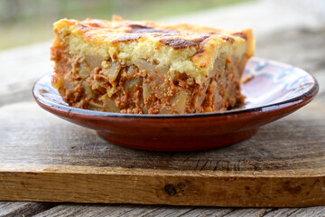  Potato and minced meat  Casserole  with   parmesan cheese and garlic on wooden rustic bakcground.  Bulgarian moussaka