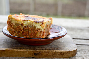  Potato and minced meat  Casserole  with   parmesan cheese and garlic on wooden rustic bakcground.  Bulgarian moussaka