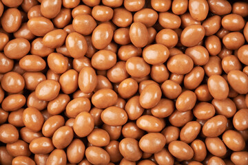 Chocolate beans candies top view, flat lay