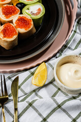 lemon wedge, mayonnaise in a ceramic saucer, light background, serving napkin