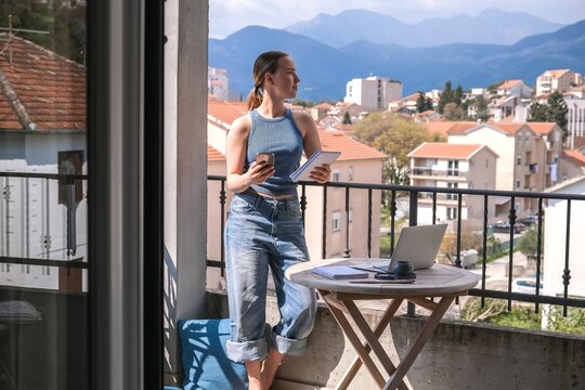 Work Remotely, Digital Nomad.digital nomad enjoys peaceful remote work setup balcony with a scenic mountain view essence of flexibility, work-life balance, and the freedom of location-independent work