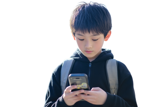 A boy is looking at his cell phone