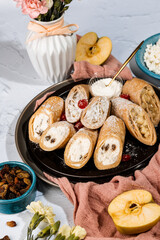 sweet rolls, pancakes with cottage cheese, raisins, apples, powdered sugar and dried cranberries, pancakes with sour cream, flatlay, beautiful light composition with dessert, roses, carnation flowers