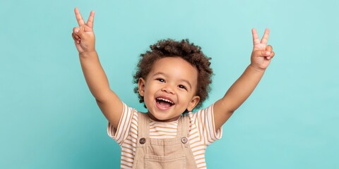 Obraz premium A cute child showing peace signs and beaming with joy. This image evokes a feeling of happiness, peace, and innocence