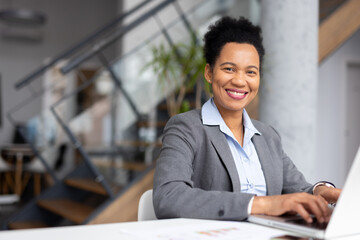 Confident African American professional managing her schedule on a laptop