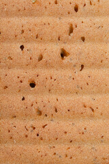 Close-up of the bottom of a loaf of bread, showcasing its golden-brown crust and texture from the baking mold