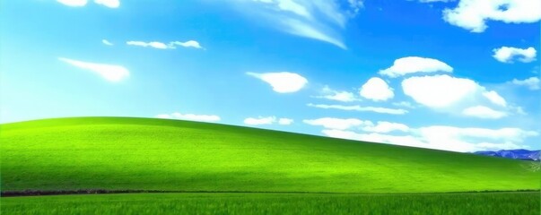 Obraz premium Soft focus of a blue sky over a rolling hill of green grass, sky, nature