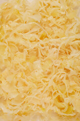 A close-up shot of sliced sauerkraut, showcasing its texture and light color
