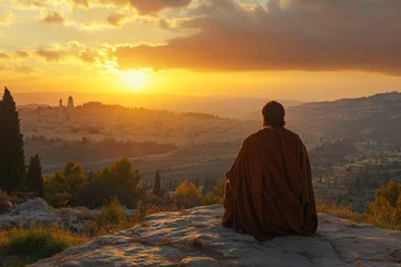 Fototapete Rund Silhouette of a meditating monk sitting on a hill during golden sunrise © Andrii Savchuk