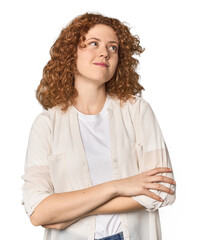 Young Caucasian redhead woman dreaming of achieving goals and purposes