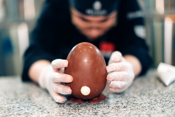 Pastry chef crafting a chocolate Easter egg