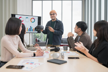Asian male businessman standing explaining meeting, smiling happily and brainstorming, discussing analysis, innovation, collaboration. online business Modern sales techniques and strategic planning