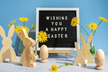 Phrase WISHING YOU A HAPPY EASTER traditional greeting to christian holiday. Festive mood...