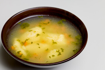 bowl of dumpling soup on a table