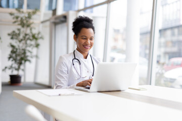 Mature African American doctor using a laptop for hospital administration