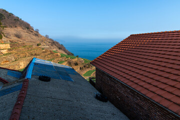 roofs of the lodges on the seaside hill
