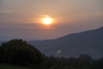 Obraz premium summer foggy sunset in the mountains.