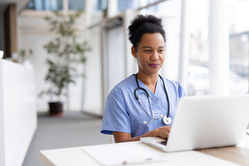 Mature African American nurse using a laptop for hospital administration