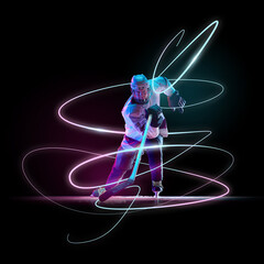 Ice hockey player in full gear skating forward, gripping stick in motion, surrounded by swirling neon light trails against dark background. Concept of sport, competition, tournament, game. © master1305