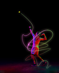 Focused man, tennis player in motion, serving ball with racket with neon green and pink light...
