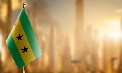 Small flags of the Sao Tome and Principe on an abstract blurry background