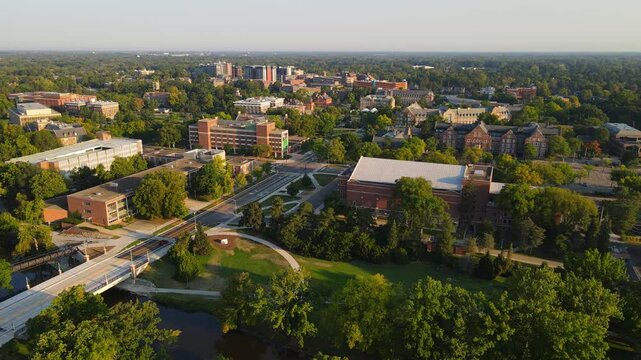 Michigan State University facilities surrounded with green trees, aerial view