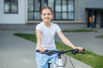 Obraz premium Tween girl riding bicycle during sunny afternoon enjoying outdoor activity