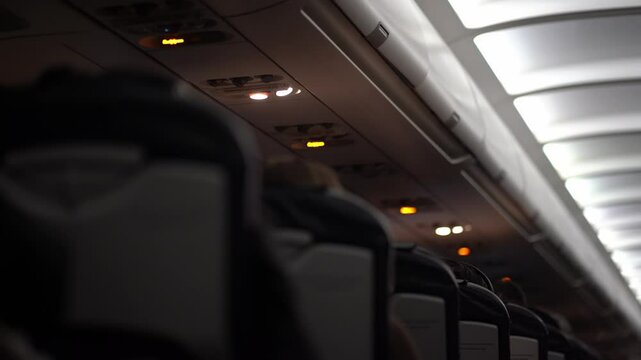 Selective focus on the ceiling of a passenger aircraft, where safety features, buttons and switches such as an oxygen mask are located. With the ability to copy. High quality 4k footage