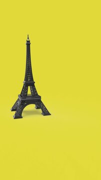 dropping eiffel tower to yellow background 