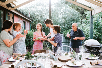 Multigeneration family gathered around the dinner table on the porch